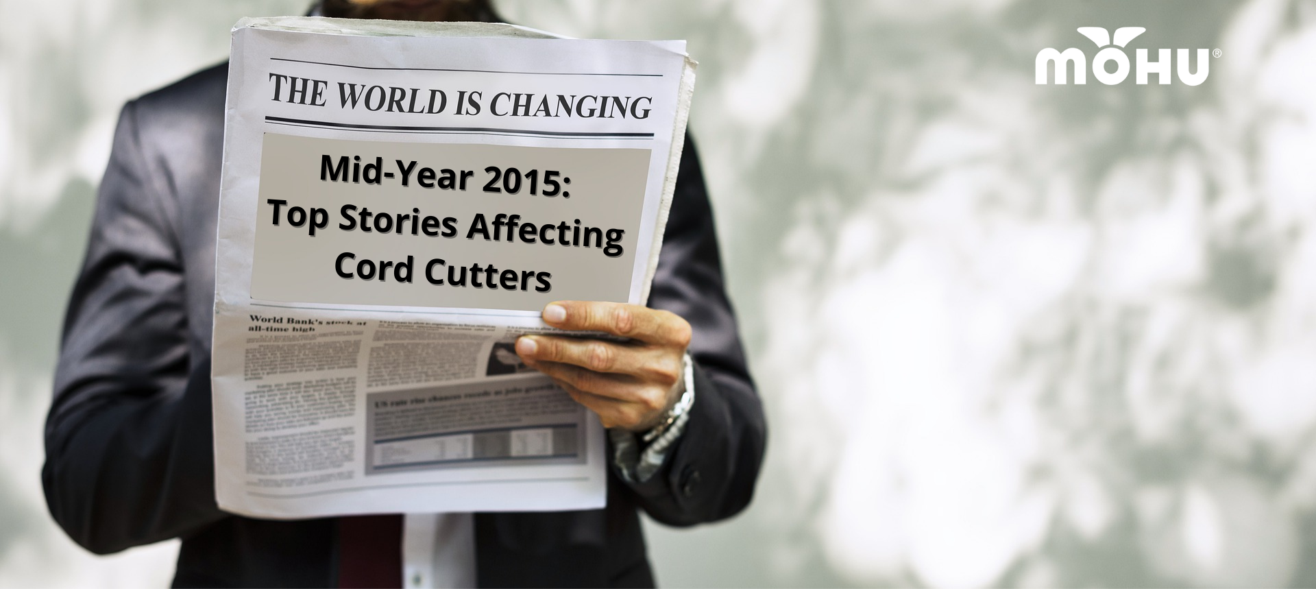 Businessman holding newspaper with the headline Mid-Year 2015: Top Stories Affecting Cord Cutters
