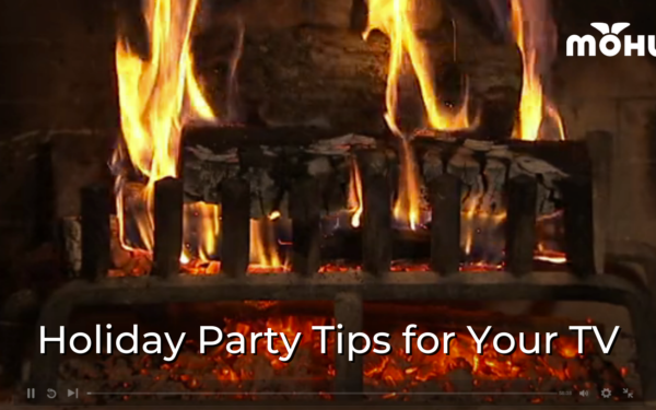 Paused video of a burning Yule log fire, Holiday Party Tips for Your TV, Mohu logo